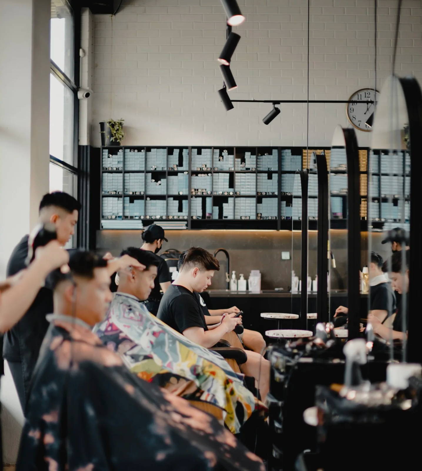 An Ultrafade barber working with a client in the salon